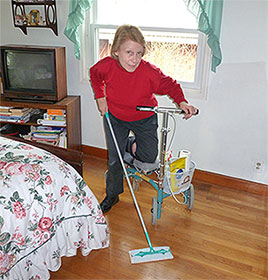 Lady doing housework on her knee scooter
