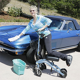 Women washing her car on her Swivelmate Knee Walker