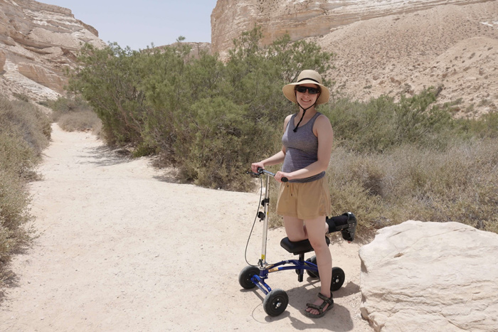 lady using knee scooter in mountains of palestine and israel