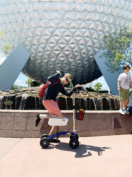 Man riding a knee scooter at Epcot