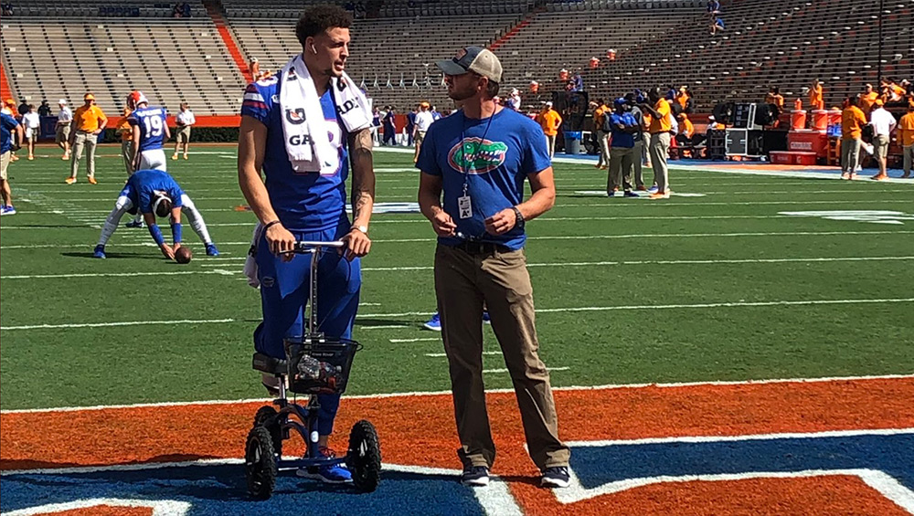 Feleipe Franks Throwing A Football On A Knee Scooter Large Image