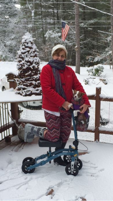 Woman on knee scooter in the snow