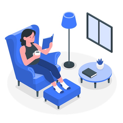 woman at home relaxing reading a book and drinking coffee