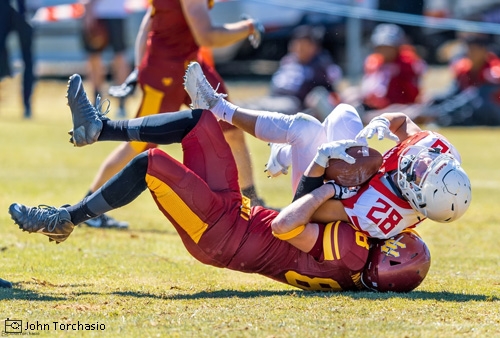 Football player getting tackled to the ground