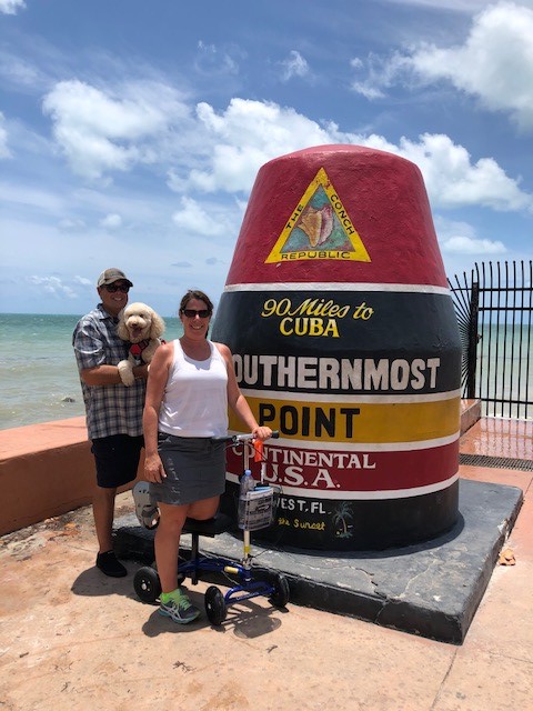 married couple, woman on a knee scooter posing at key west florida