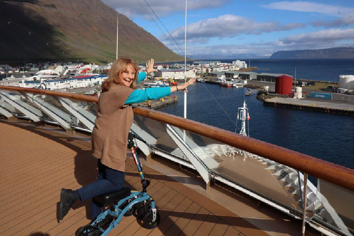 lady posing on a boat and cruise with other boats in the background