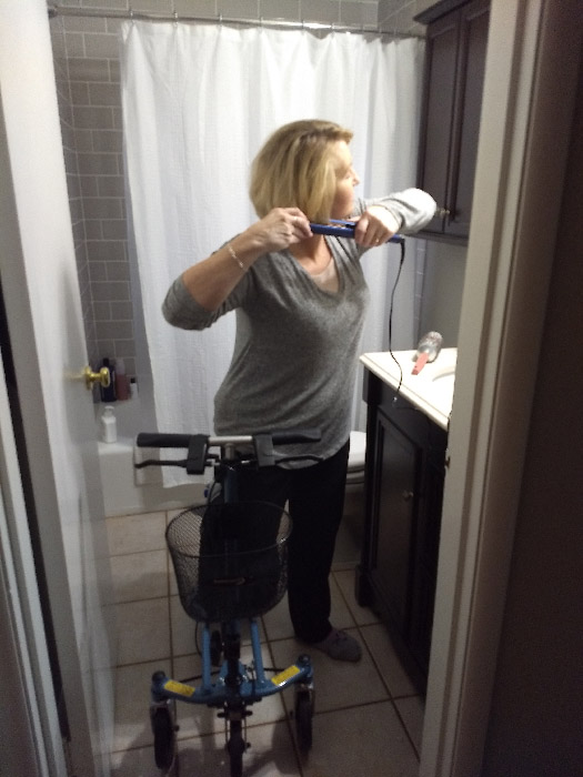 woman in bathroom doing her hair