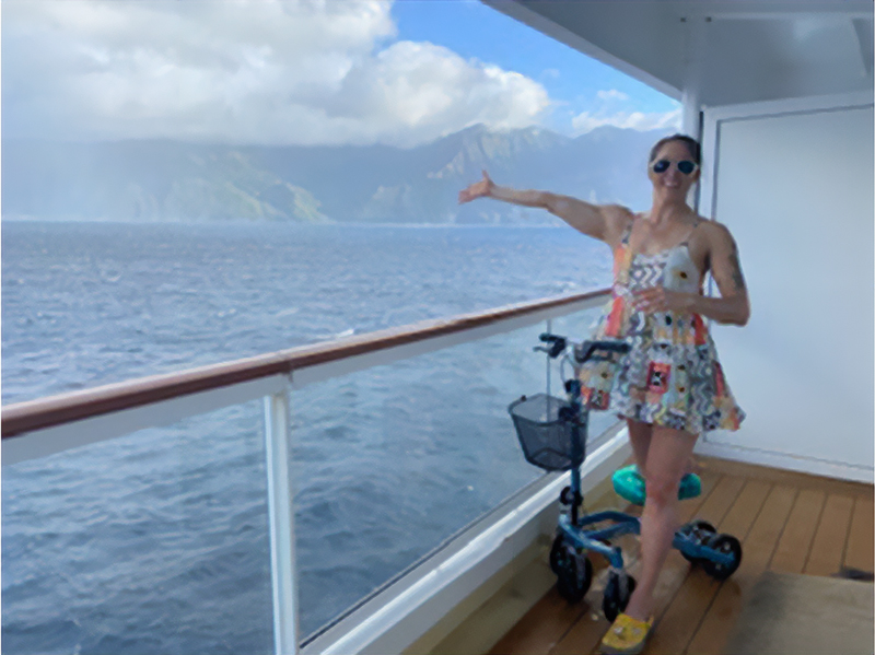 lady posing with a knee scooter in a cruise