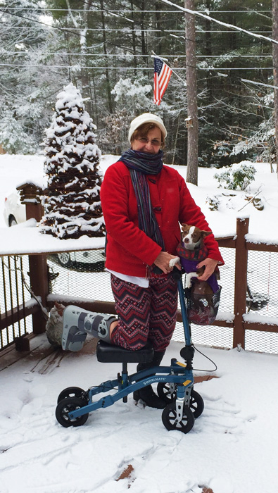 lady posing with her knee scooter outdoors 