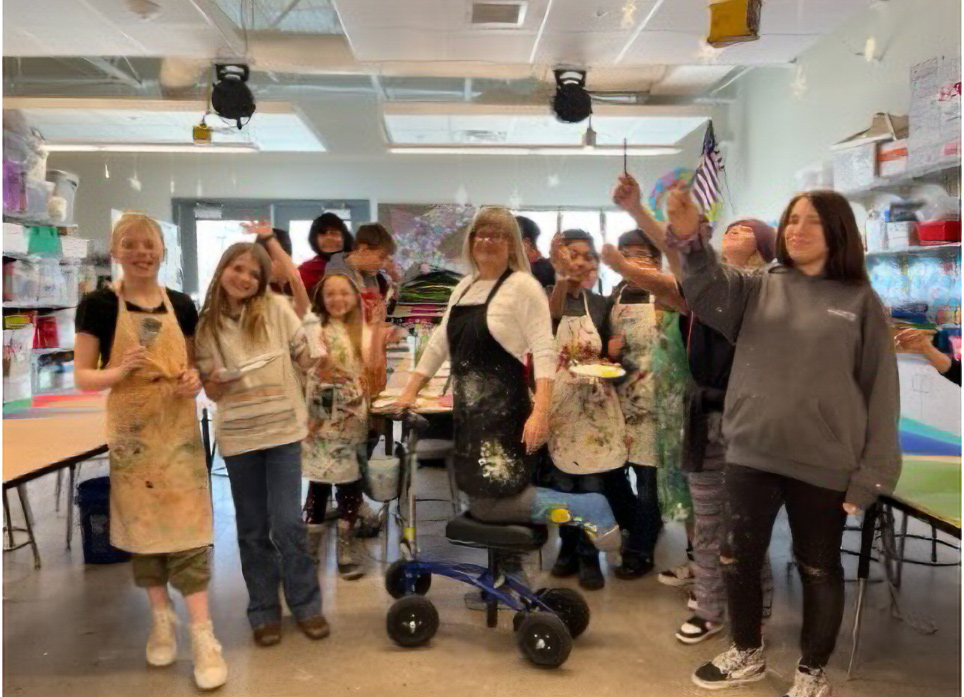 a teacher posing with her students