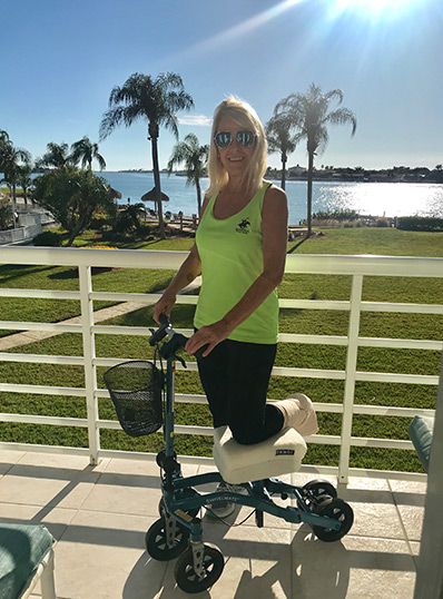 lady on knee scooter at the beach