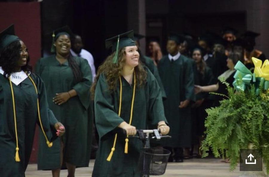 Woman graduating on knee scooter