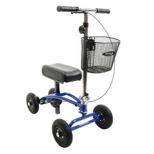 An Orthomate knee scooter equipped with a padded seat, smaller tires, and a wire basket hanging in front of the handlebar for carrying items, suitable for indoor or smoother outdoor surfaces.