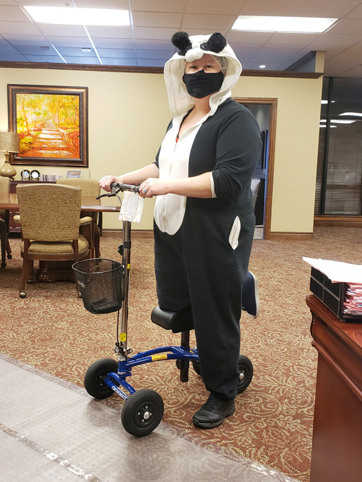 lady in halloween costume in a knee scooter