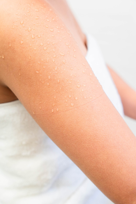 the arm of a model showing how dry it can keep her protected side.