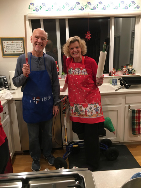 wife on a knee scooter posing with husband in the kitchen