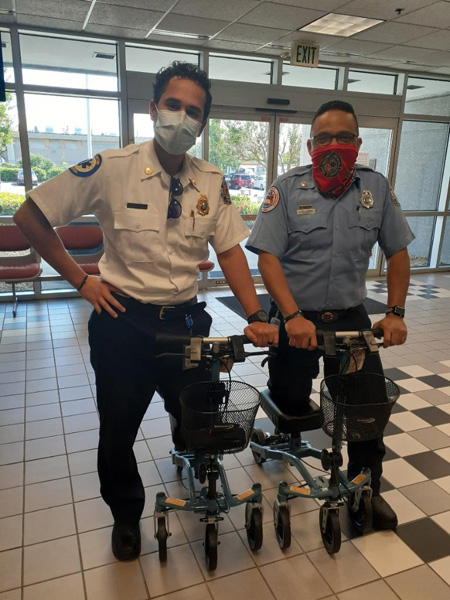 two firemen on knee scooters