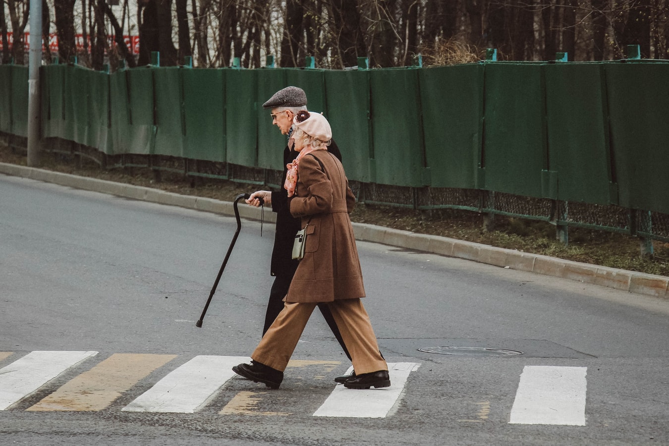 man and woman walking with cane