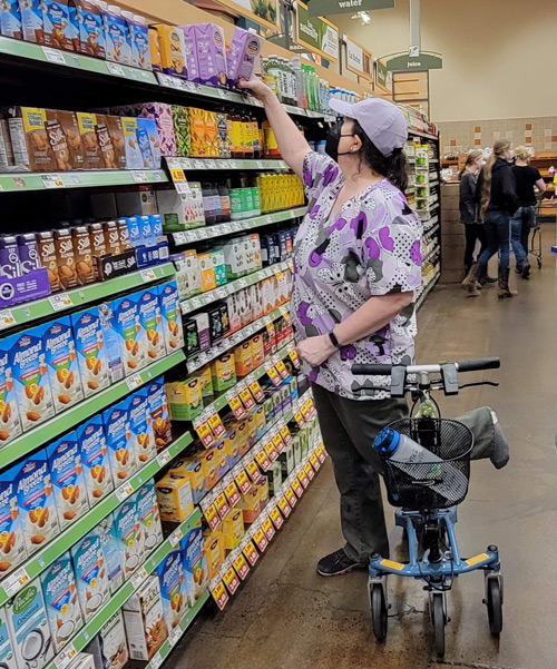 lady on a knee scooter at a supermarket